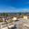 a rooftop with a deck and chairs