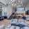 a room with a staircase and a couch and a table