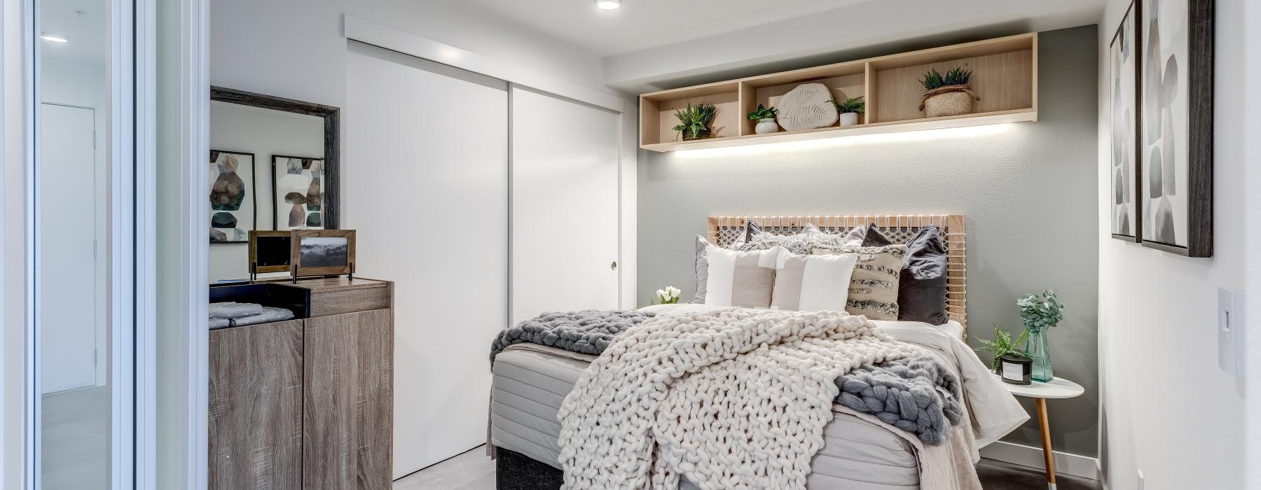 a bedroom with a bed and a shelf